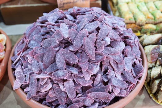 Dehydrated purple pineapple. Slices displayed at street market stall