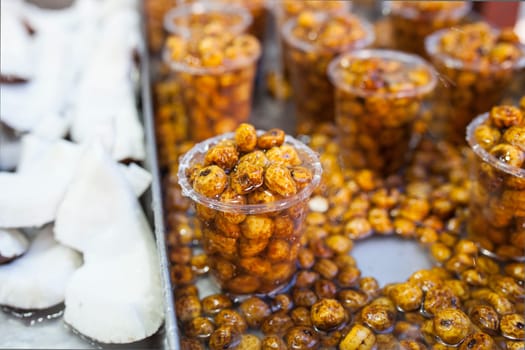 Glasses with tiger nuts or chufas. Water drops falling on cups displayed at street market stall