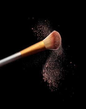 Make up brush with cosmetic powder splash, over black background. Splash image