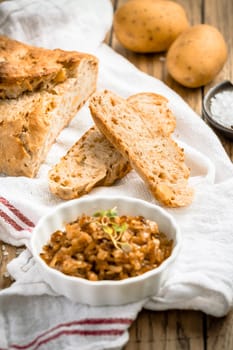Potato bread with spelt flour and roasted onions on wooden table
