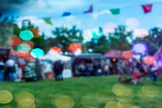 Abstract blur image of food stalls and trucks. Blur image of street festival with bokeh for background usage