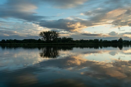 The reflection of the evening clouds in the lake water, Stankow, Poland