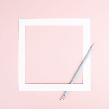 Pencil on a pink paper background, white frame with copy space for text, minimalism, creative and business concept, pastel colored