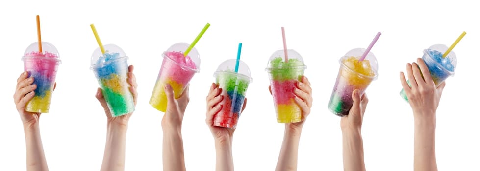Hands of crop unrecognizable people holding plastic cups with colorful refreshing slush beverages with straws against white background in studio