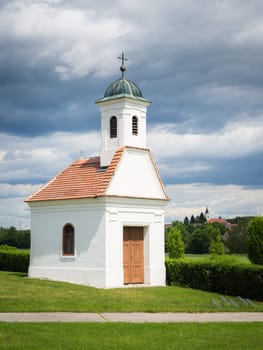 Small church on green field in rural spring landscape, Burgenland, Austria