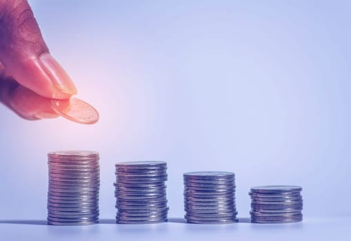 Save money and account banking for finance concept, Hand with coin on blurred background, Save Monney for Investors Using Internet to Trade Stocks or Trade Fund