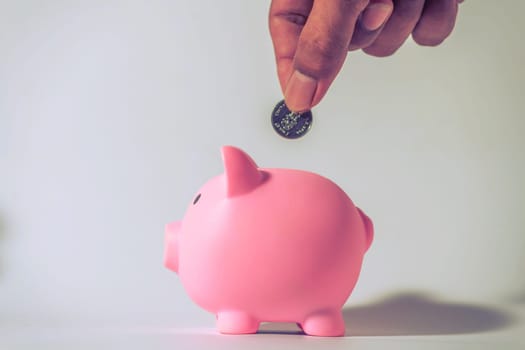 Save money and account banking for finance concept, Hand with piggy bank and coin on blurred background, Save Monney for Investors Using Internet to Trade Stocks or Trade Fund