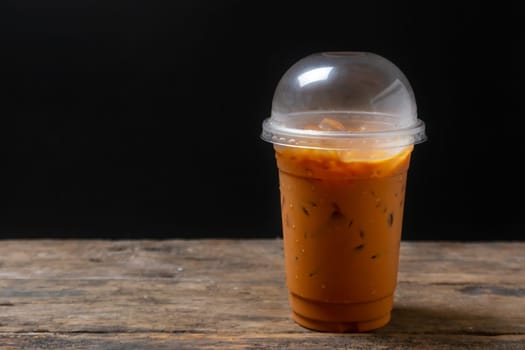 Tea thai, Ice tea milk or Ice milk tea, Sweet drink, Blurred black background