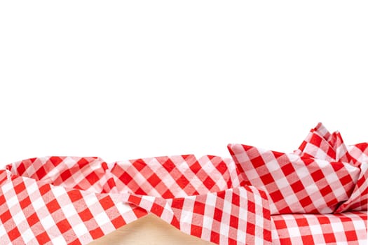 Closeup of a empty straw basket with a red checkered napkin and a folded ship isolated on a white background. For your food and product display montage. Macro.