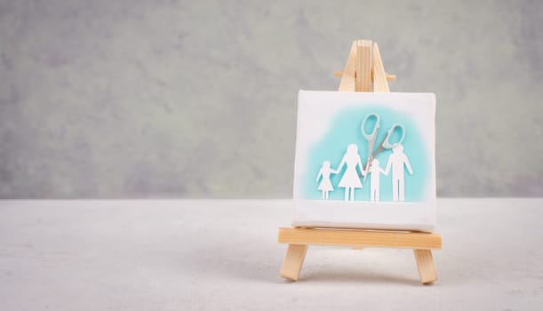 Divored parents, custody battle for the children, scissors cut the family, paper cut out, conflict in relationship, broken marriage concept