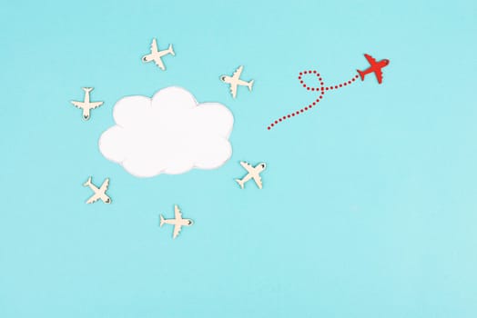 Group of airplanes flying in a circle around a cloud, red plane thinks different and takes the opposite direction, against the stream symbolic, courage and winner concept