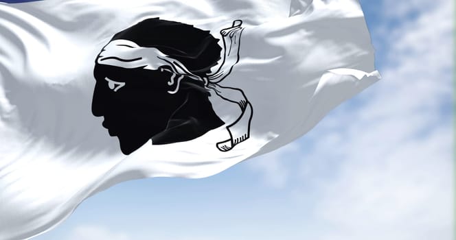 The flag of Corsica waving in the wind on a clear day. The Corsica is an island of the Mediterranean Sea and French administrative region