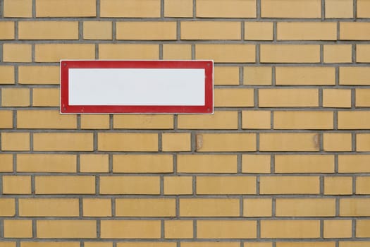 blank white sign with text free space on brick wall