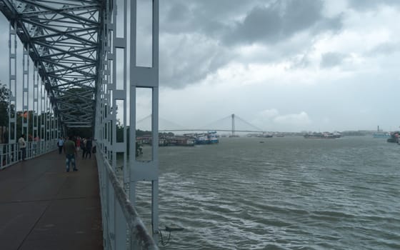 Kolkata Riverside Landscape View on a Dark cloudy day. View from Babu Ghat Footbridge. Kolkata West Bengal India South Asia 19 June 2022