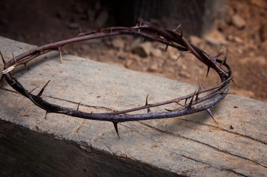 Copy space for Christian prayer text or quote with crown of thorns on old wood. Copy space