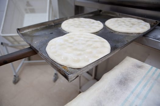 Elaboration process of traditional spanish olive oil pancakes. Pancakes ready for baking