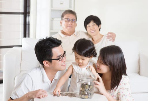Asian family money savings concept. Multi generations living lifestyle at home.