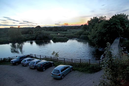 A sunset in the countryside with a lake
