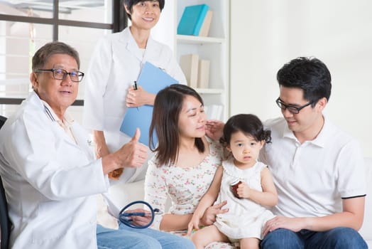 Pediatrician giving a thumb up after examined child. Pediatrician and patient healthcare concept.