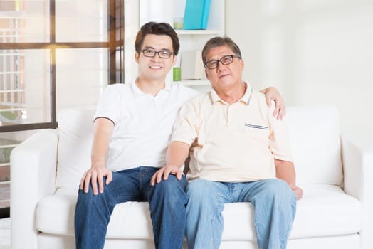 Asian senior father and adult son at home. Family living lifestyle.