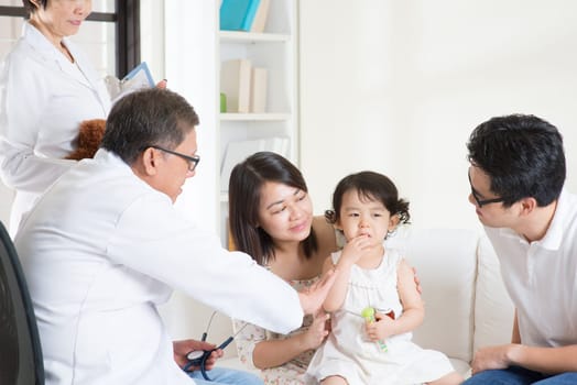 Toddler cries when consult family doctor. Pediatrician and patient healthcare concept.