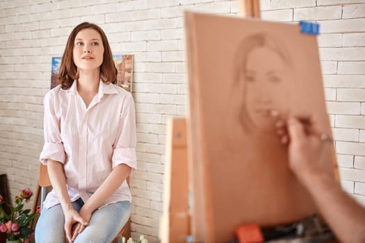 Young woman sitting in artist studio