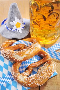 original Bavarian laugenbrezeln with Oktoberfest beer mug and traditional hat