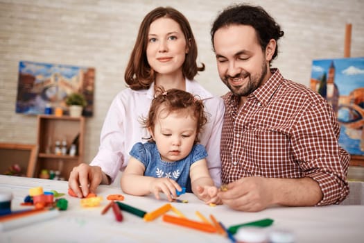 Young couple and cute girl having rest at home