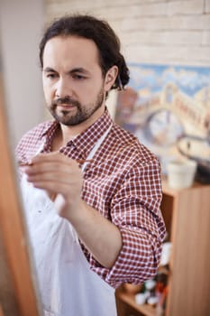 Modern artist painting in studio
