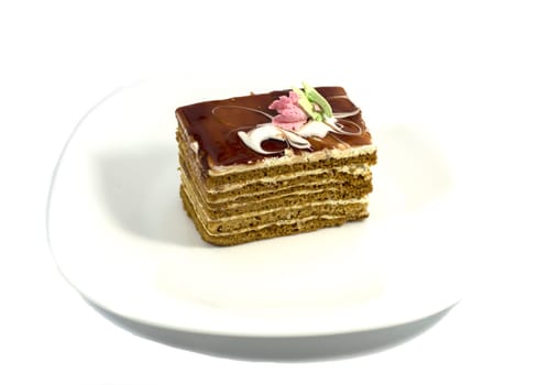 brown cake on a white plate, on a white background