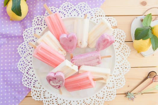 Various colorful ice cream on stem on vintage plate