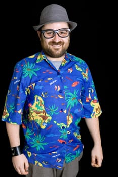 young happy man with a hawaiian shirt on black background