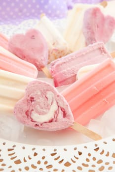 Various colorful ice cream on stem on vintage plate