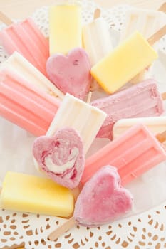 Various colorful ice cream on stem on vintage plate