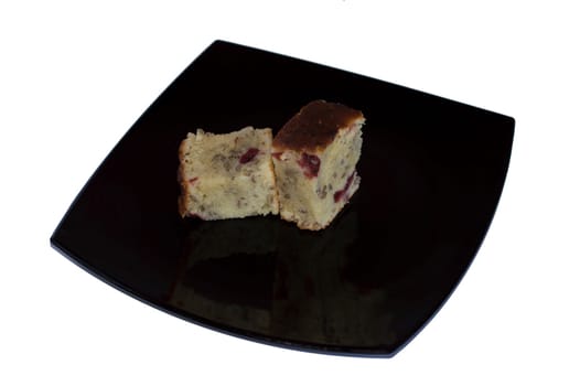 two slices of pie with cherry, in the center of a black plate
