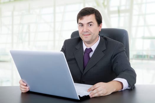 young businessman working with is laptop, at the office