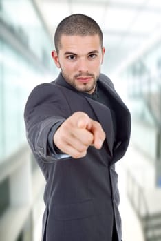 young business man in a suit pointing with his finger