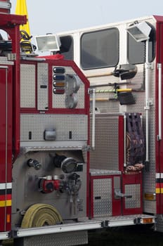 Detail of portion of fire truck showing hoses and tools.
