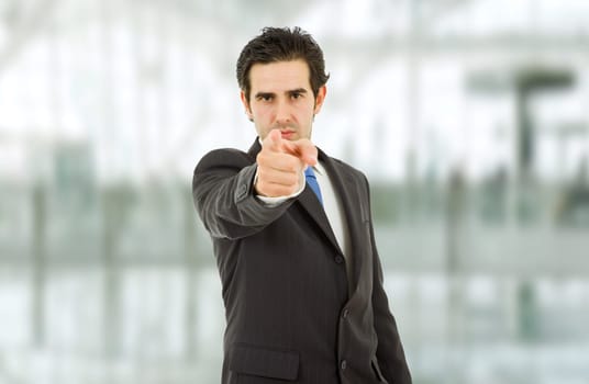young business man in a suit pointing with his finger