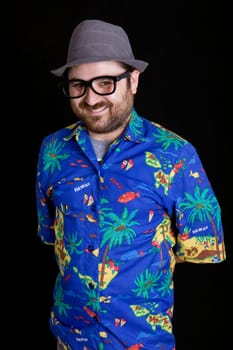 young happy man with a hawaiian shirt on black background