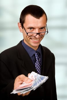 young business man with money at the office