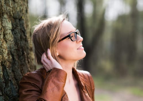 Young woman with glasses in nature