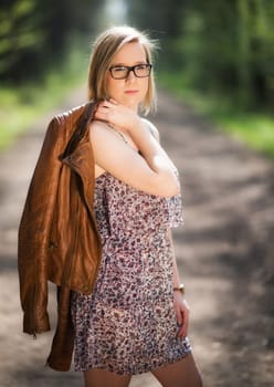 Young woman on forest trail in spring