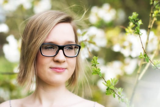 Young woman with glasses in spring