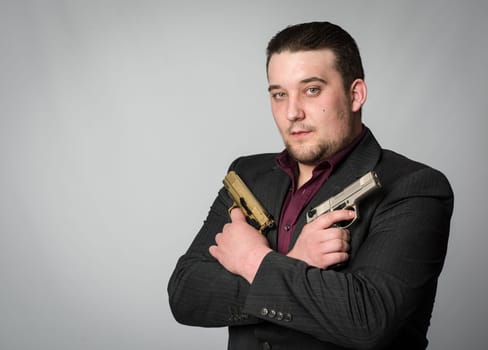Young man with two weapons