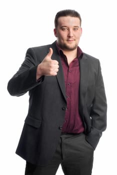Young man in suit shows thumbs up