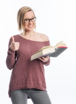 Young woman with book shows thumbs up