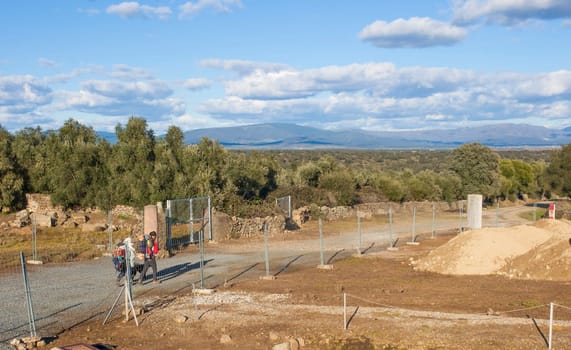 Via de la Plata pilgrims crossing remains of Roman city of Caparra, Caceres, Extremadura, Spain