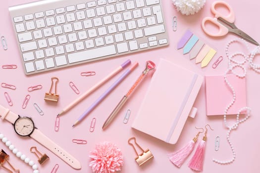 Hardcover notebook, Pink school accessories and keyboard on light pink, Top view, textbook mockup. Girly workplace with notebook, scissors, pencil, pen, paperclips, cards and watch. Back to school