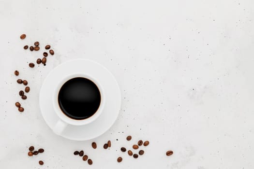 Top view on flat lay with single one full coffee cup composition on gray white concrete background. Tea mug collection layout. Dried coffee beans around. Black espresso or americano. Copy space area